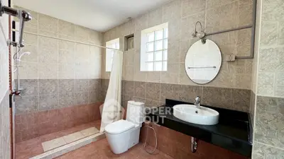 Spacious modern bathroom with elegant tile design and sleek fixtures