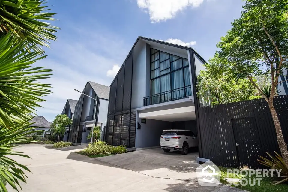 Modern townhouse with sleek design and spacious driveway in a serene neighborhood.