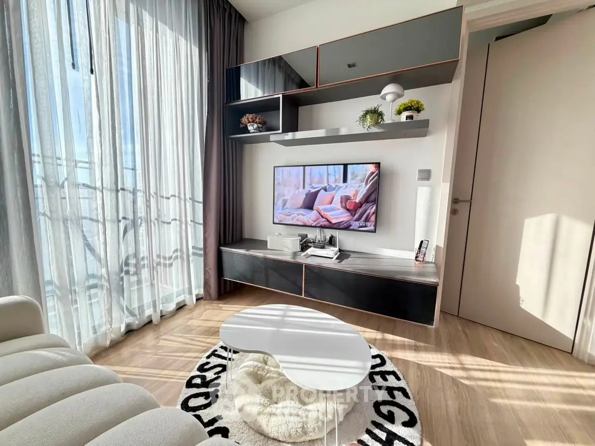 Modern living room with stylish furniture and large windows offering abundant natural light.