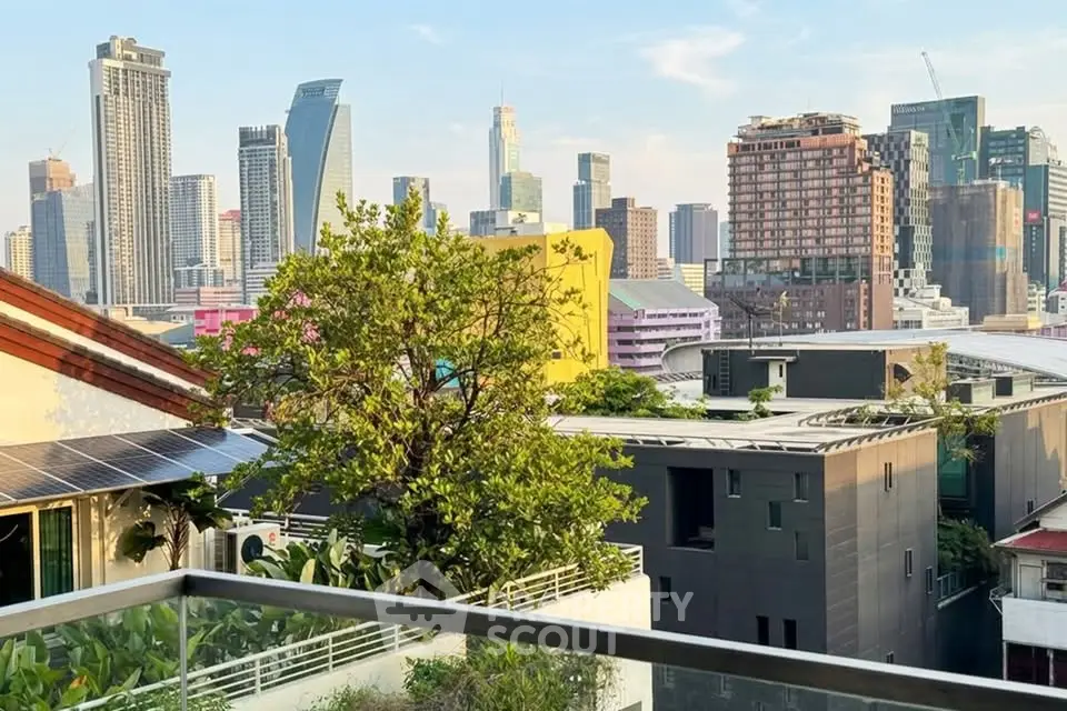 Stunning cityscape view from a modern balcony with lush greenery and urban skyline.