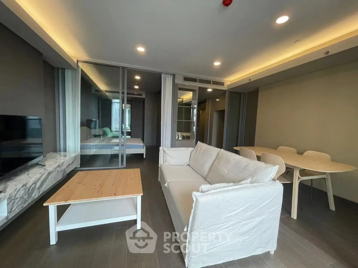 Modern living room with white sofa and wooden furniture in open layout