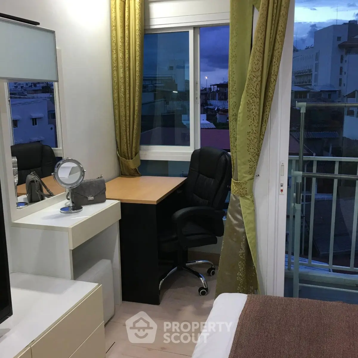Cozy bedroom with study area and balcony view, perfect for urban living.