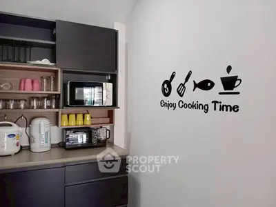 Modern kitchen with stylish wall decor and appliances, perfect for culinary enthusiasts.