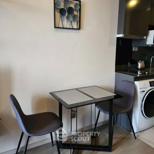 Modern compact kitchen with dining area and washing machine