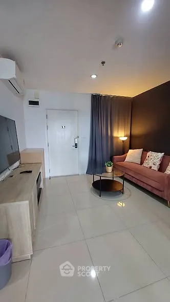 Modern living room with sleek design, featuring a cozy sofa, stylish coffee table, and wall-mounted TV.