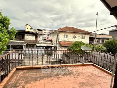 Spacious balcony with urban view, perfect for relaxation and enjoying city life.