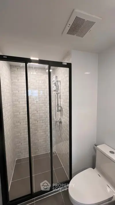Modern bathroom with sleek shower and contemporary toilet design.