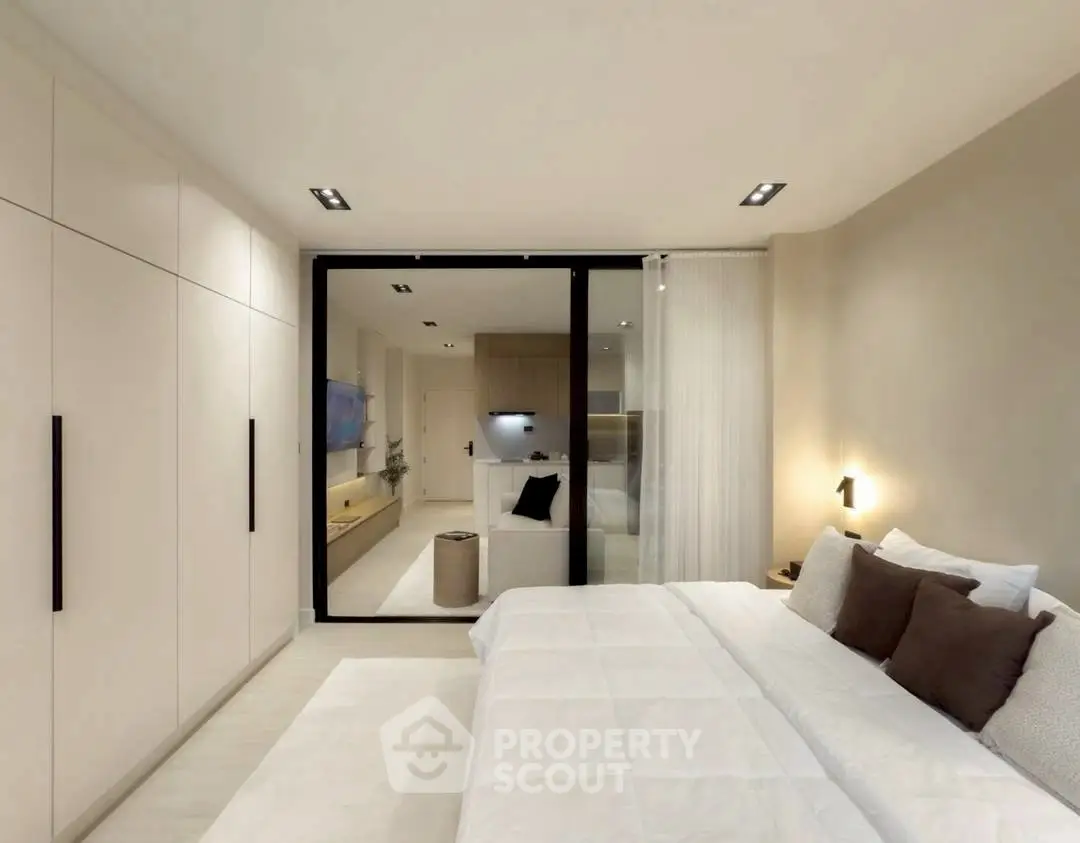 Modern bedroom with sleek design and neutral tones, featuring a spacious layout and stylish decor.