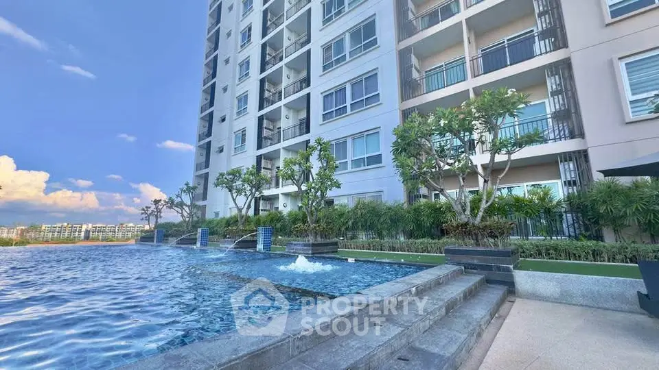 Luxurious condominium with stunning poolside view and modern architecture.