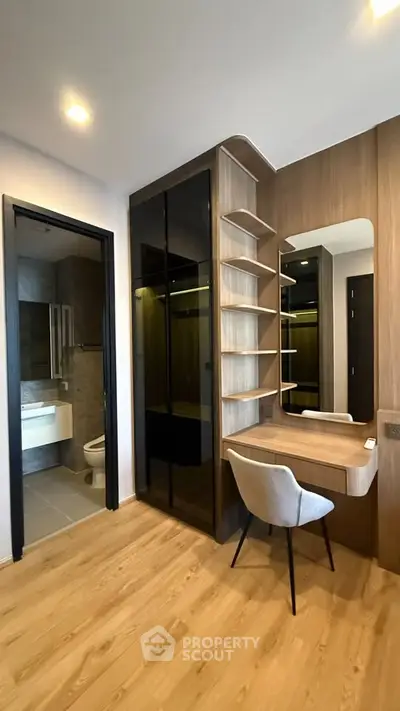Modern bedroom with built-in wardrobe and stylish vanity area