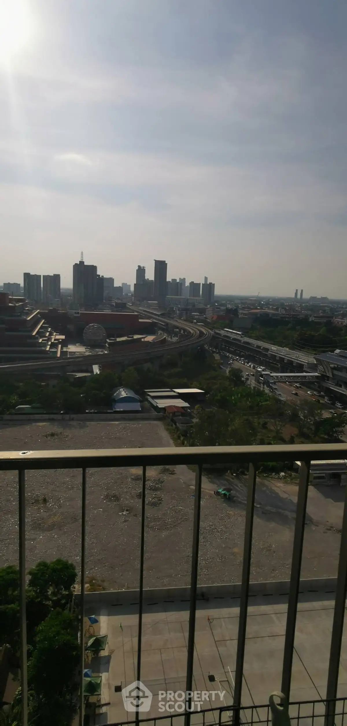 Stunning cityscape view from high-rise balcony with urban skyline.