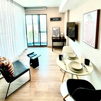 Modern living room with stylish decor and large windows offering natural light.