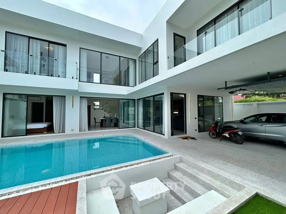 Luxurious modern villa with pool and spacious balcony, perfect for elegant living.