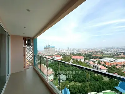 Spacious balcony with stunning city view in modern high-rise apartment