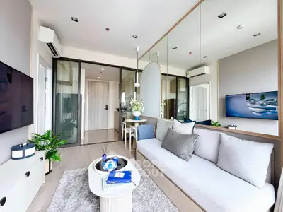 Modern living room with stylish decor and large mirror wall