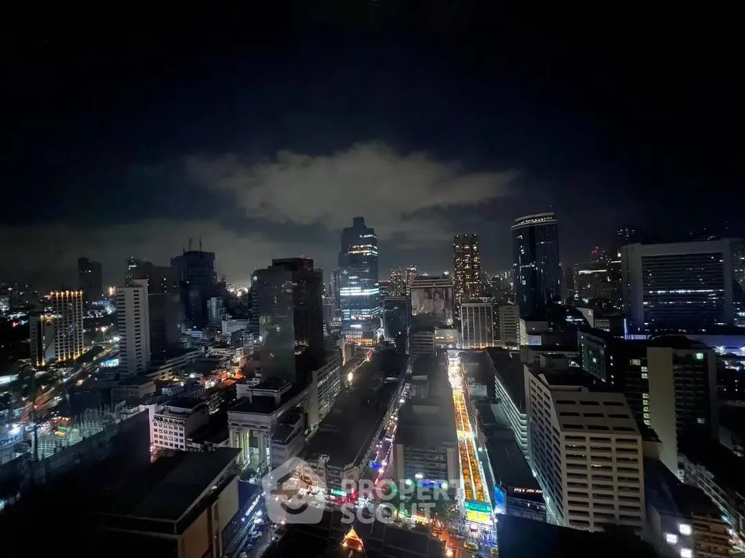 Stunning night cityscape view from a high-rise building, showcasing vibrant urban lights.