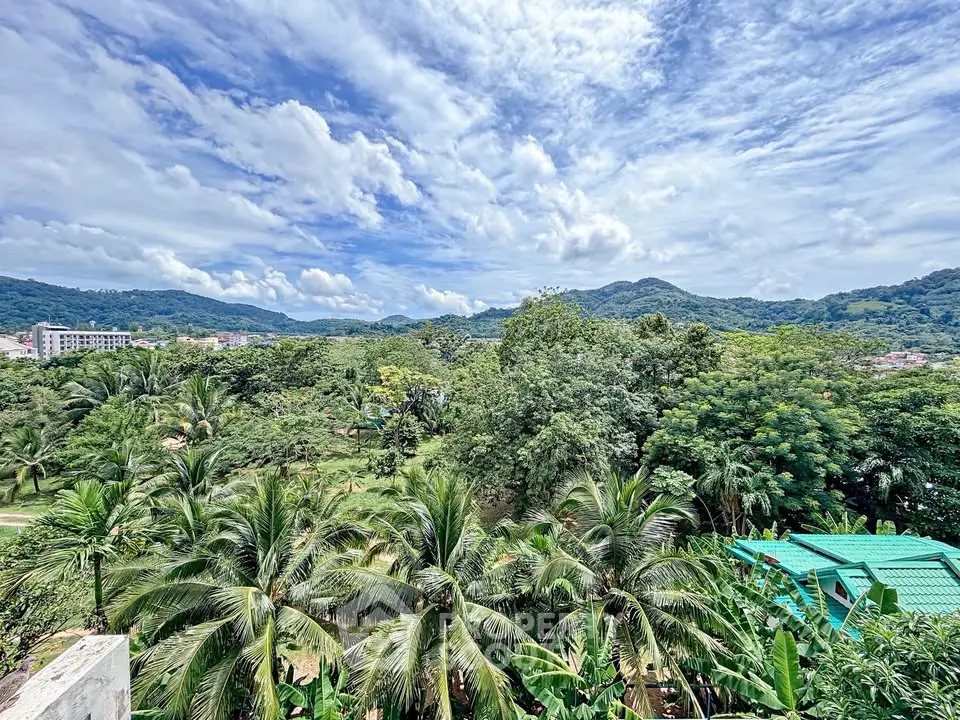 Stunning panoramic view of lush greenery and mountains from a tropical property, perfect for nature lovers.
