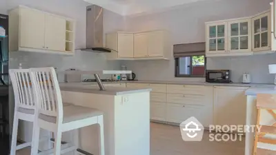 Spacious kitchen with modern appliances and ample storage in a bright, airy home.