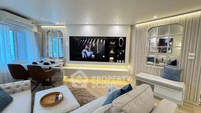 Luxurious living room with modern decor and large TV, perfect for entertainment.