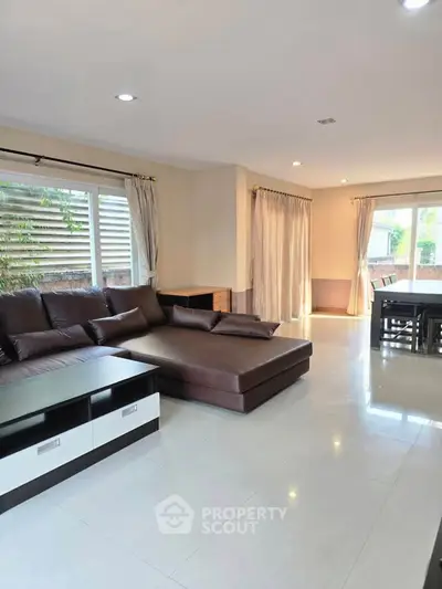 Spacious living room with modern furniture and large windows for natural light.