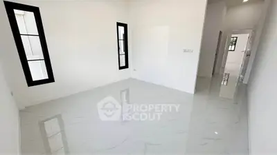Spacious modern living room with glossy white marble flooring and large windows.