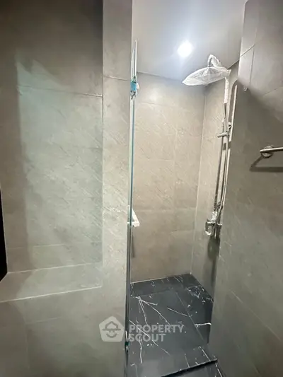 Modern bathroom with sleek shower design and elegant tile finish.