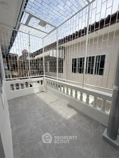 Spacious balcony with modern railing and tiled flooring, perfect for relaxation and outdoor enjoyment.