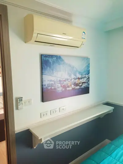 Cozy bedroom with air conditioning and scenic wall art, perfect for relaxation.