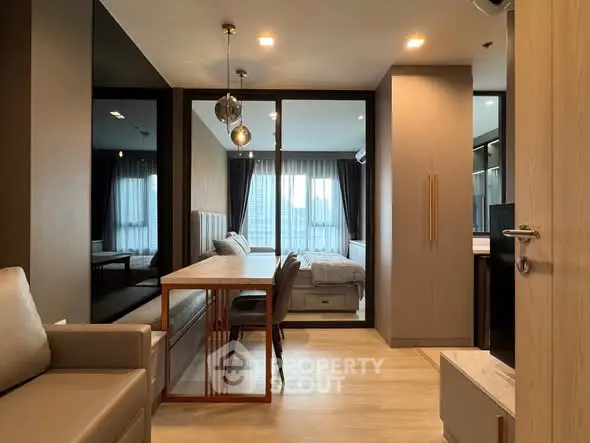 Modern apartment interior with open layout, featuring a cozy living area and stylish dining space.