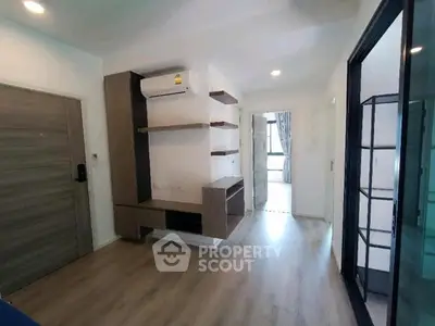 Modern apartment interior with wooden flooring and built-in shelves