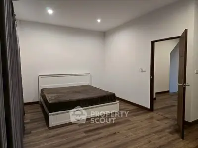Spacious bedroom with modern design and wooden flooring