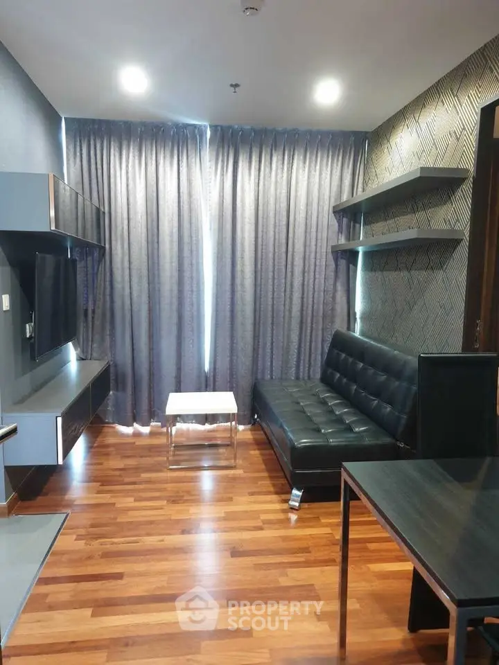 Modern living room with sleek furniture and wooden flooring, perfect for urban living.