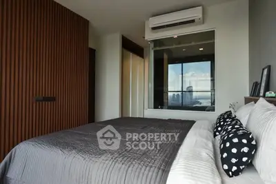 Modern bedroom with city view and stylish wooden paneling