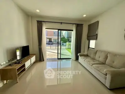 Spacious living room with modern decor and large window view