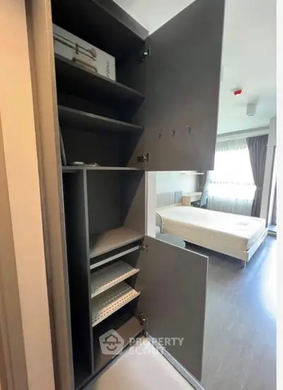 Modern bedroom with open closet showcasing ample storage space and natural light.