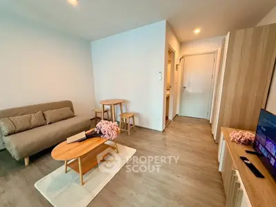 Modern living room with cozy sofa, wooden furniture, and stylish decor in a bright apartment.