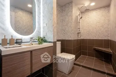 Modern bathroom with stylish tiles and illuminated mirror