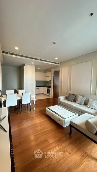 Elegant living room with modern furniture and open kitchen layout