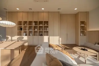 Modern living room with elegant wooden shelving and cozy seating area