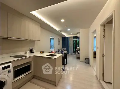 Modern open-layout kitchen and living room with sleek design and natural light