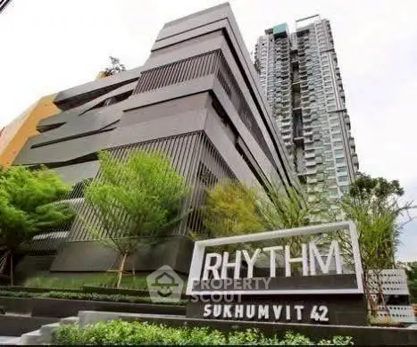Modern high-rise condominium building with lush greenery at Rhythm Sukhumvit 42.