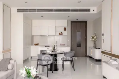Modern open-plan living room and kitchen with sleek design and elegant furnishings.