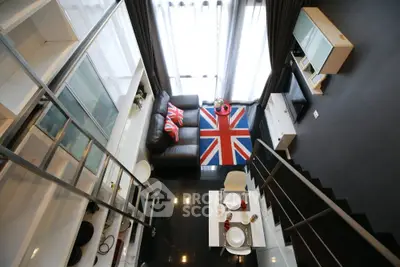Modern loft apartment with stylish interior and Union Jack decor, featuring open living and dining area.