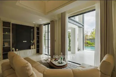 Luxurious living room with elegant decor and pool view, perfect for relaxation and entertainment.