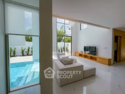 Luxurious living room with pool view and modern decor