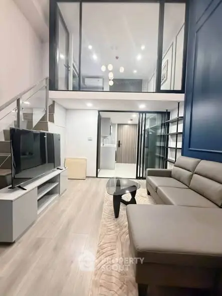 Modern loft-style living room with sleek furniture and high ceilings