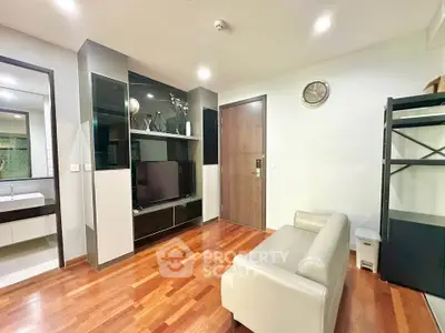 Modern living room with sleek wooden flooring and stylish shelving unit