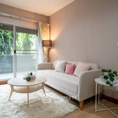 Cozy living room with elegant sofa and lush balcony view