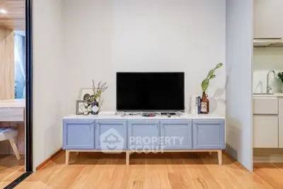 Modern living room with stylish TV console and wooden flooring