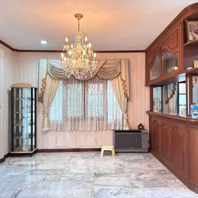 Elegant living room with chandelier and classic wooden cabinetry